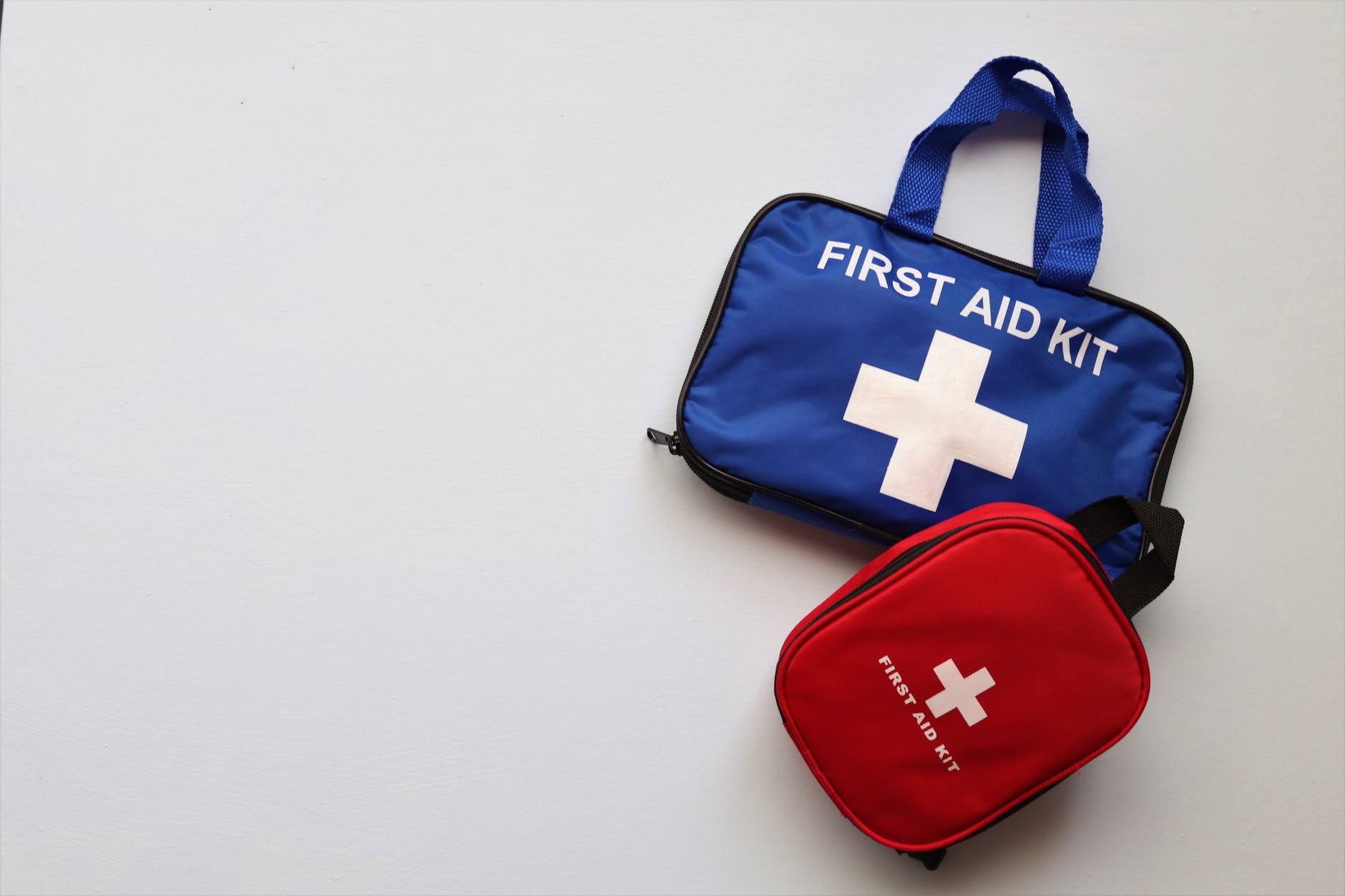 a blue and red first aid kit bags